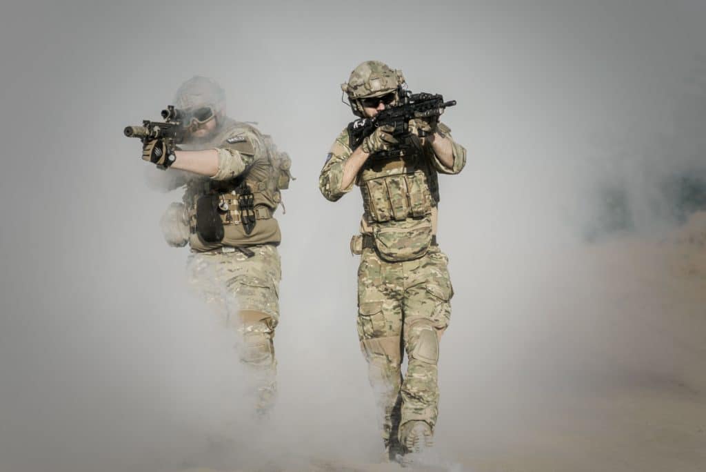 two soldiers in smoke holding rifles