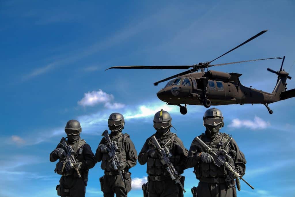 Four US military soldiers and helicopter