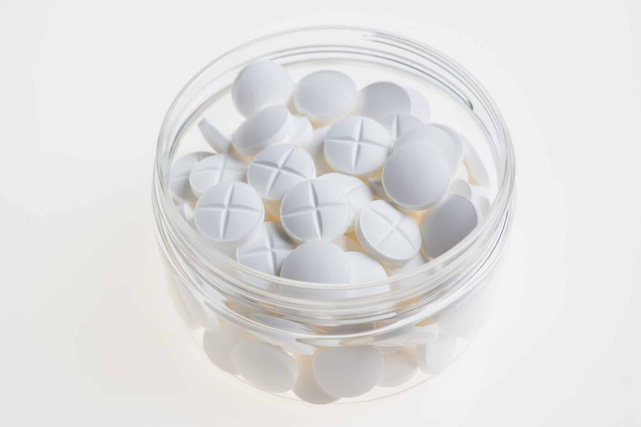 white pills in a clear container