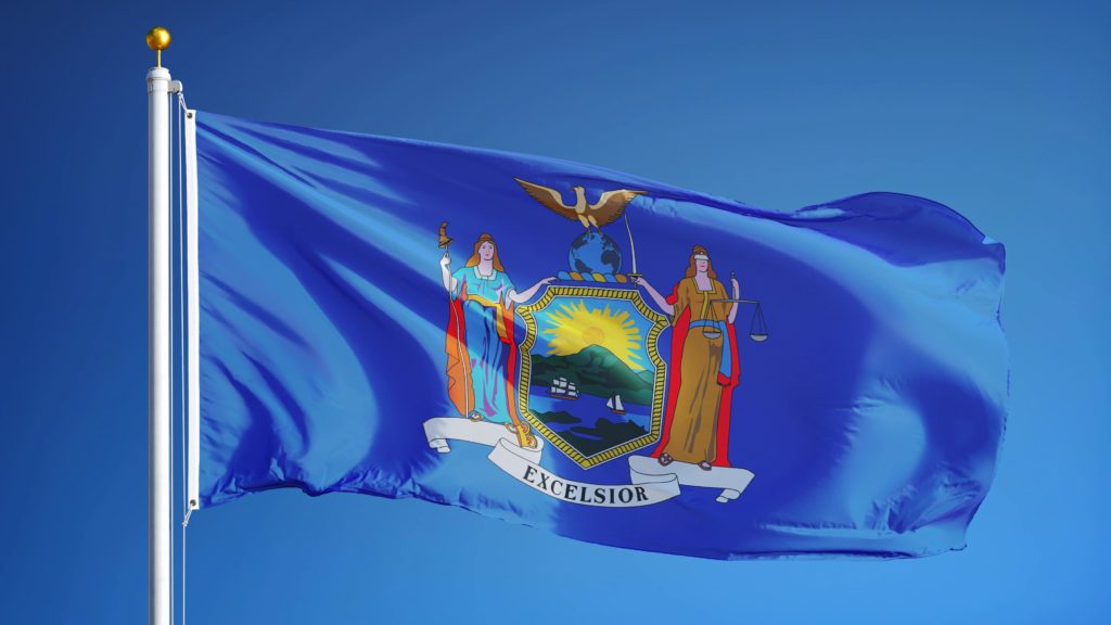 New York state flag against blue sky