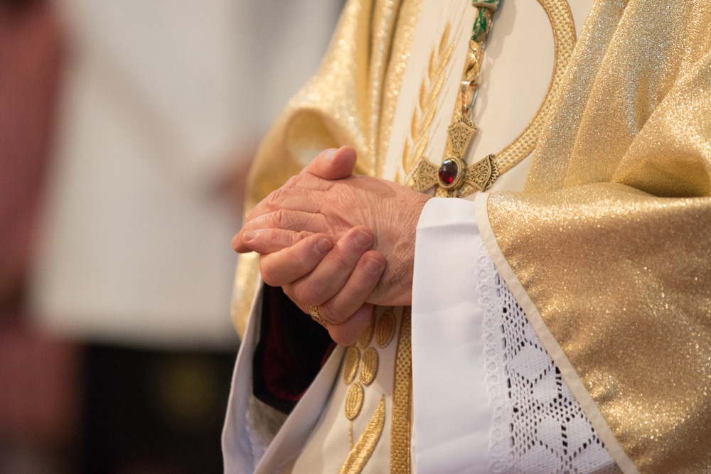 Catholic priest praying - Catholic clergy sexual abuse
