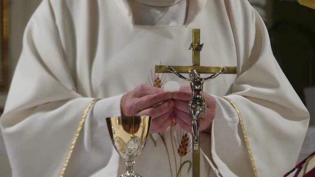 Catholic Priest holding communion wafer