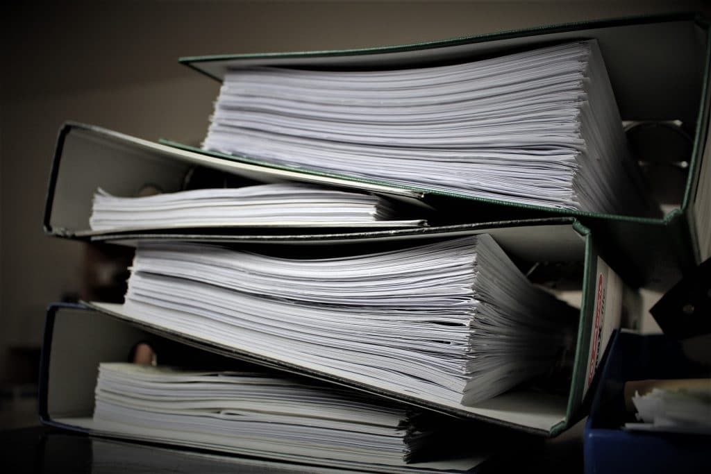 stack of lawsuits in binders